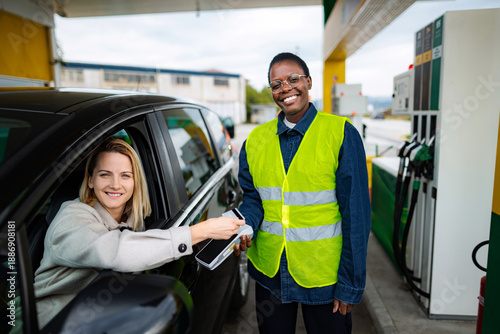 Wallpaper Mural Gas station worker helping customer with contactless payment Torontodigital.ca