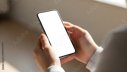 Wallpaper Mural Close-up of a person holding a modern smartphone with a blank white screen in their hands, ready for use or content display Torontodigital.ca