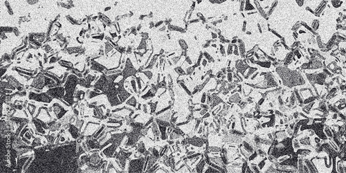 Abstract grayscale textured background with irregular geometric shapes and granular noise creating a complex organic pattern resembling cellular structures or fractured surfaces, perfect for