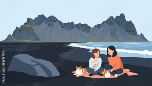 Two women and dogs enjoying a scenic picnic on a black sand beach