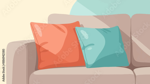 Two soft pillows, one coral, one teal, rest on a neutral sofa