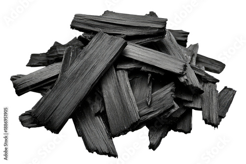 Pile of dark, charred wood pieces, angled and textured