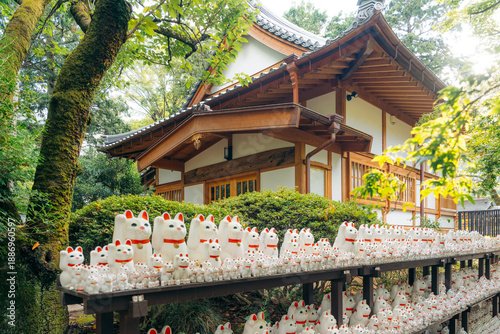 Canvas Print Maneki neko statues at a Japanese temple in Tokyo, Japan, offering good fortune