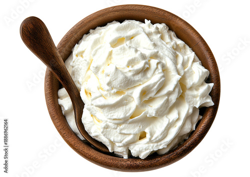 Creamy white topping in a wooden bowl with spoon