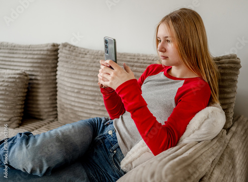 Wallpaper Mural Girl Writing Message On Smartphone While Lying On The Couch Torontodigital.ca