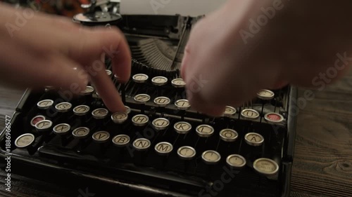 Woman hands typing on keyboard with fingers vintage typewriter close up