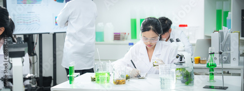 Scientists conducting plant-based biotechnology research in a modern laboratory, showcasing sustainability, clean energy, climate action, and green innovation for ESG and corporate communication.