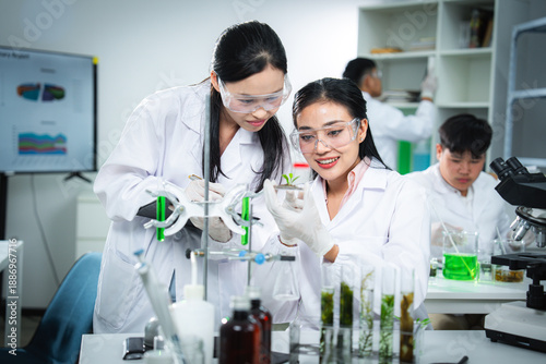 Scientists collaborating on plant biotechnology research in laboratory, highlighting teamwork, sustainability, clean energy, and climate action for ESG, green innovation, and corporate communication