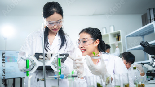 Scientists discussing plant-based biotechnology in a modern laboratory, highlighting teamwork, collaboration, sustainability, clean energy, and climate action for ESG and corporate communication.