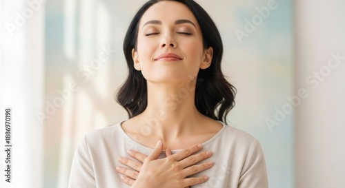 Woman eyes closed, hands on chest, light background, serene expression Free Download Woman eyes closed, hands on chest, light background, serene expression - GFXLoad