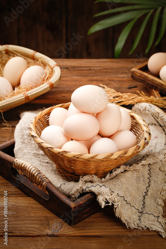 Fresh Farm Eggs with White Shells in Wicker Baskets on Rustic Wood Background