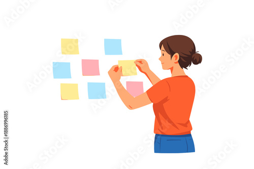 Woman arranging sticky notes on a wall in a bright room during the day while planning her work and organizing tasks for a project