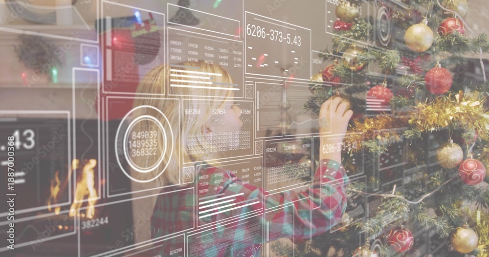 Fototapeta premium Reaching plaid-shirted boy placing red ornament on Christmas tree at home, HUD panels and fireplace