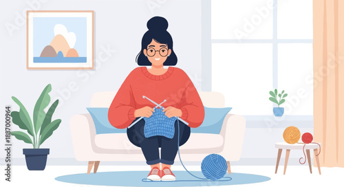 Woman knitting a blue fabric while sitting on a couch with yarn