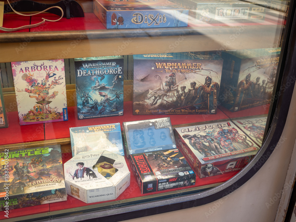 Fototapeta premium Board games display in a retail store window featuring various popular tabletop games and fantasy strategy sets