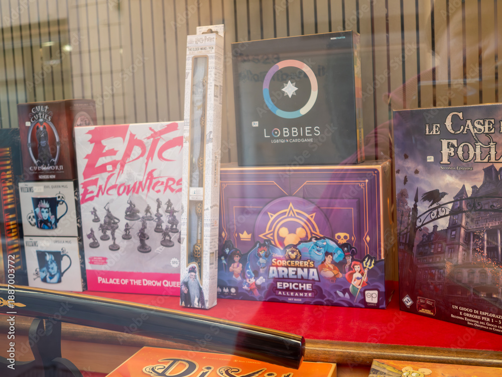 Fototapeta premium Variety of board games, card games, and character merchandise for sale in a retail store window, attracting customers