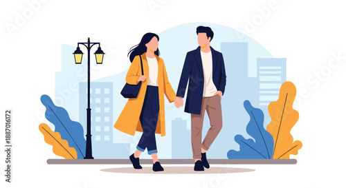 Stylish young couple in autumn coats holding hands and walking together on a date in a city park with a street lamp in the background.