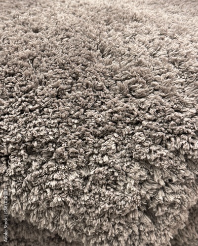 Close up of grey or beige textured deep pile carpet or rug