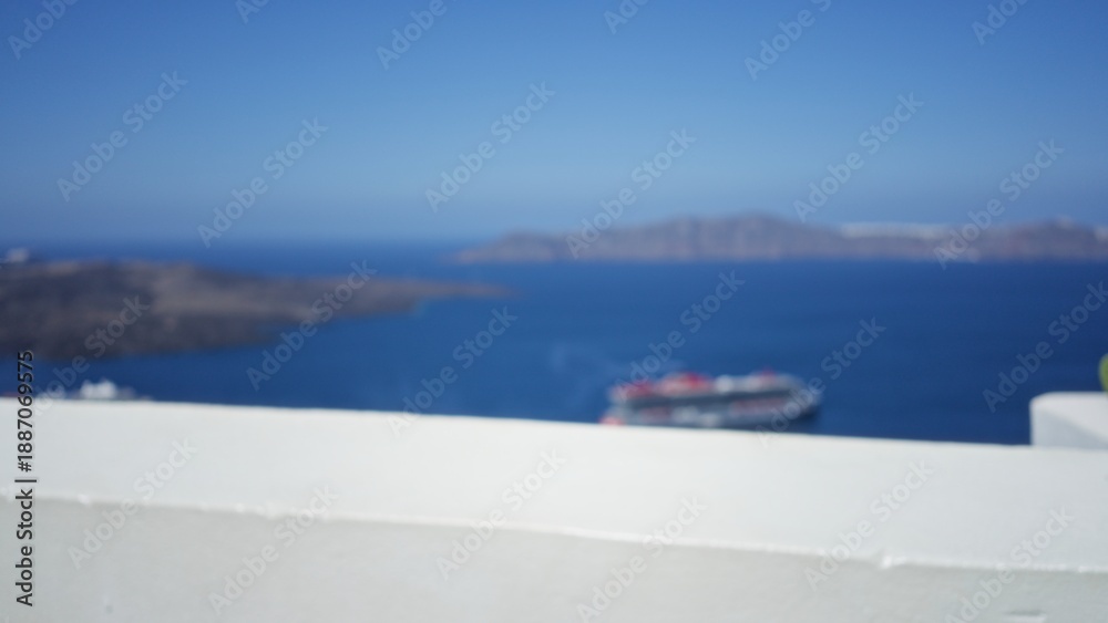 Naklejka premium Blurred coastal seascape with soft bokeh and white foreground wall outdoor; backdrop copyspace backplate.