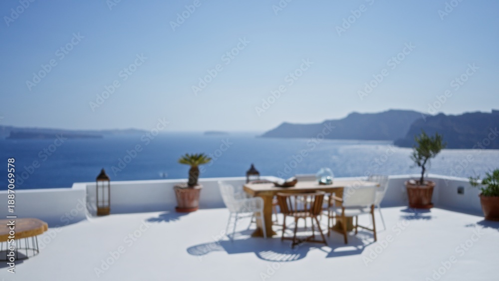 Fototapeta premium Sunny white terrace with blurred shallow focus sea view and distant island silhouette outdoor; background backplate copyspace calm.
