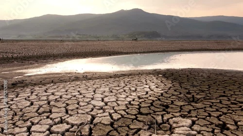 Cinematic View of Cracked Earth and Dried Lake Bed Due to Drought. relentless heat of the sun, Concept of Climate Change, Global Warming, and Water Scarcity in a Barren Landscape.