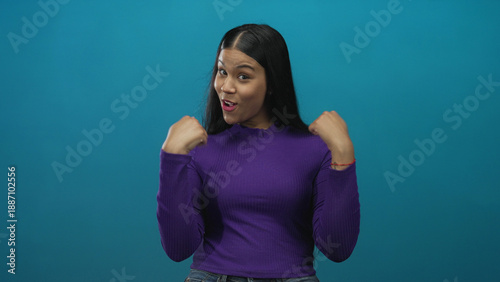 Fotografía Woman in purple sweater smiling while pointing thumbs to herself in brightly lit studio; self confidence