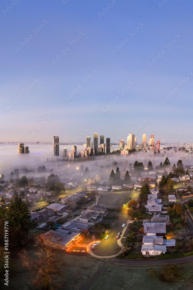 Obraz premium Sunrise Over Foggy Vancouver Skyline With Urban Core And Suburban Neighborhoods, BC, Canada