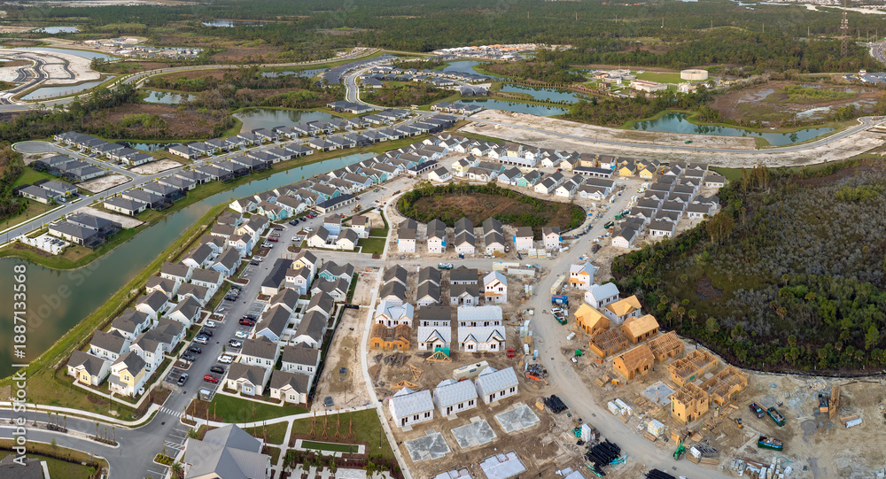 Fototapeta premium Wooden houses under construction in new developing suburban area. Development of residential housing in American suburbs. Real estate market in the USA