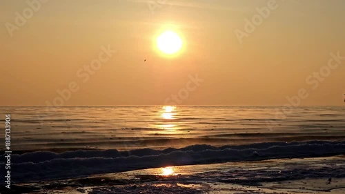 Sea smoke rising from water at sunrise, creating a dramatic and serene natural scene.
