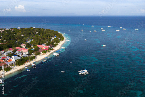 Stunning White Sandbar of Kalanggaman Island with Traditional Bangka Boats Docked in the Philippines.