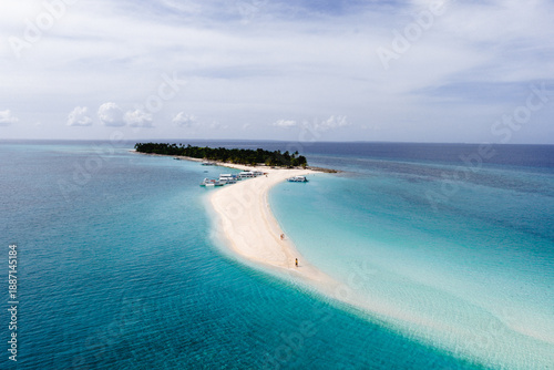 Stunning White Sandbar of Kalanggaman Island with Traditional Bangka Boats Docked in the Philippines.