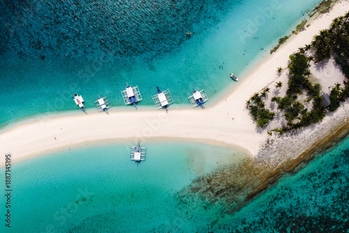 Stunning White Sandbar of Kalanggaman Island with Traditional Bangka Boats Docked in the Philippines.