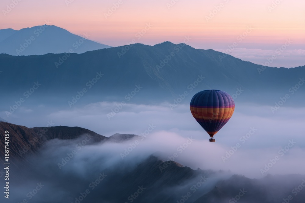 Fototapeta premium Vibrant hot air balloon marvel over serene misty mountains at sunrise