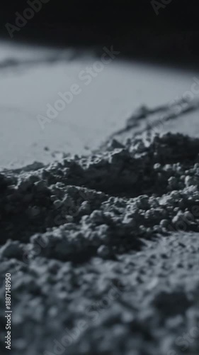 Dynamic Macro View Of Fine Gray Powder Movement And Textured Surface Creates Abstract Patterns