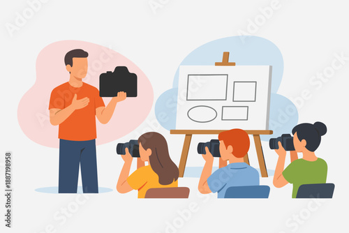 Male photographer teaching children photography concepts in classroom setting