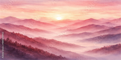 A misty sunrise glows over the blue mountain landscape as light breaks through the morning fog and clouds in the snow covered valley

