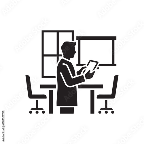 Businessman standing in office holding tablet