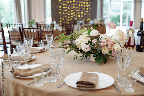 Tableau sur toile Close-up of wedding table setting with crystal glassware, plates, and beige napkins