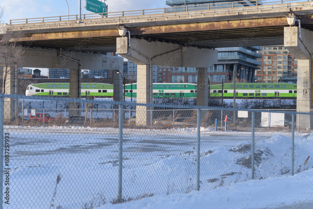 Obraz premium view of elevated Gardiner Expressway and Go Train heading westbound into the downtown core from Cherry St, Toronto