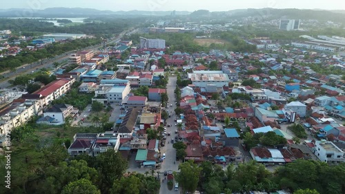 A panoramic aerial view of a vibrant tropical urban landscape with bustling streets