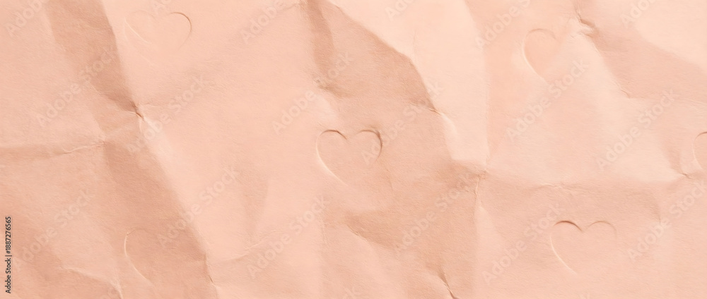 Fototapeta premium Crumpled pastel pink paper texture with embossed heart shapes. Wrinkled page background for Valentine's Day love letter concept