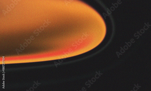 Vibrant orange and red light streak on a dark grainy background with retro aesthetic film grain and artistic blur effects