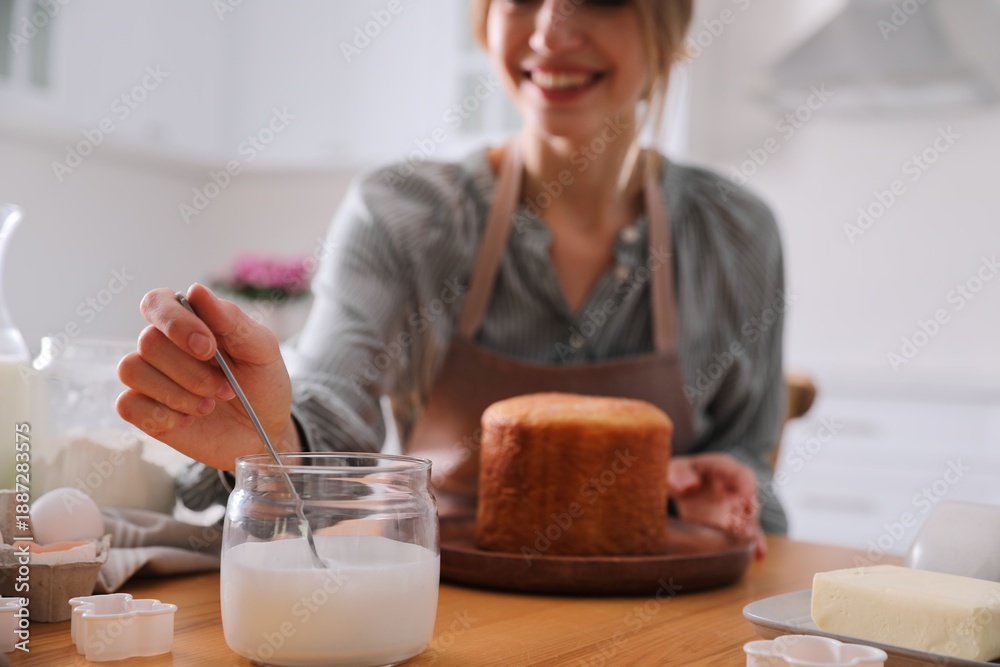 © New Africa - Young woman making traditional Easter cake in kitchen, closeup