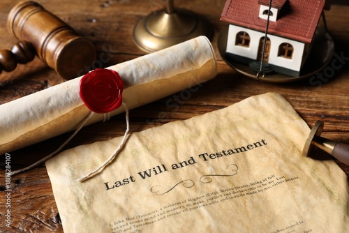 Fotografi Last Will and Testament, gavel, scroll and house model on wooden table, closeup