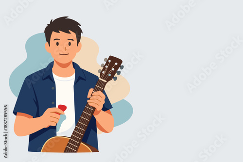 Smiling young caucasian male holding guitar with pick