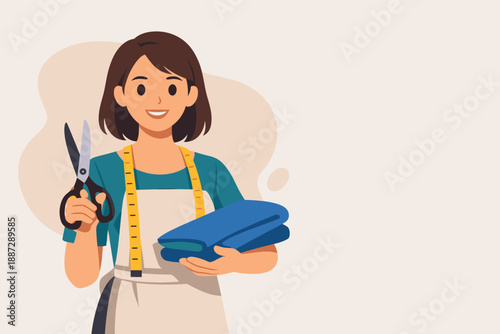 Young female caucasian tailor with scissors and fabric in workshop