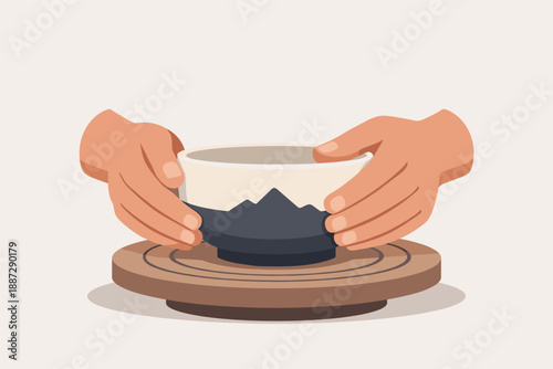Hands holding ceramic bowl on wooden pottery wheel