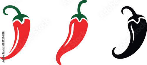 Three chili peppers in red and black color isolated on white background