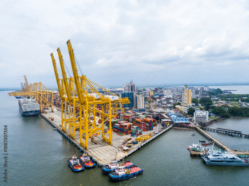 Obraz premium Buenaventura industrial port aerial view with yellow cargo cranes and containers