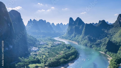 Aerial time-lapse of Li River winding through karst peaks , traditional villages and scenic valleys near Yangshuo, Guilin, China